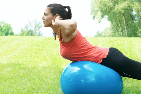 Fitness girl doing exercise with pilates ball outdoors Stock Photo