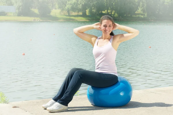 Fitness women exercising with pilates ball outdoors — Stok fotoğraf