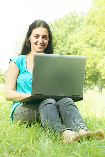 Piękny szczęśliwy uczeń korzysta z laptopa na zewnątrz. — Zdjęcie stockowe
