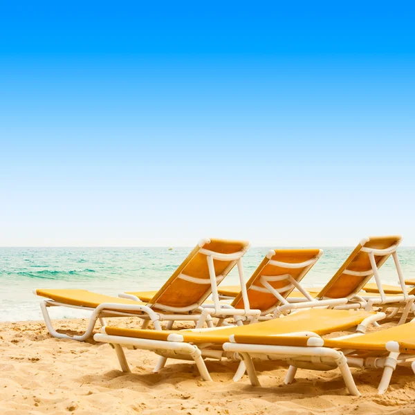 Camas de sol na praia arenosa — Fotografia de Stock