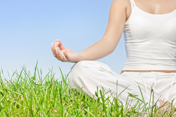 Closeup of woman hands in meditation outdoors