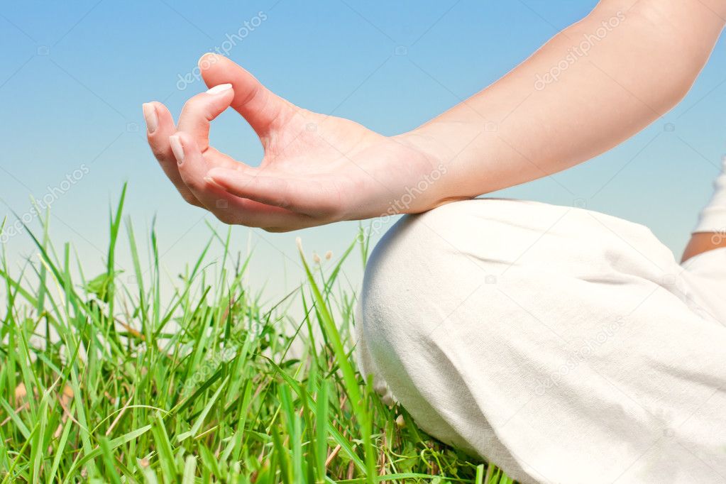 Closeup of woman hands in yoga pose outdoors