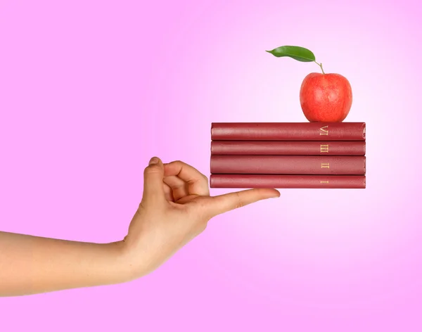 Libros con manzana en la mano como regalo de educación —  Fotos de Stock