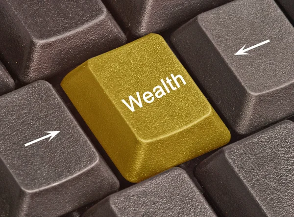 Teclado com chave para a riqueza — Fotografia de Stock