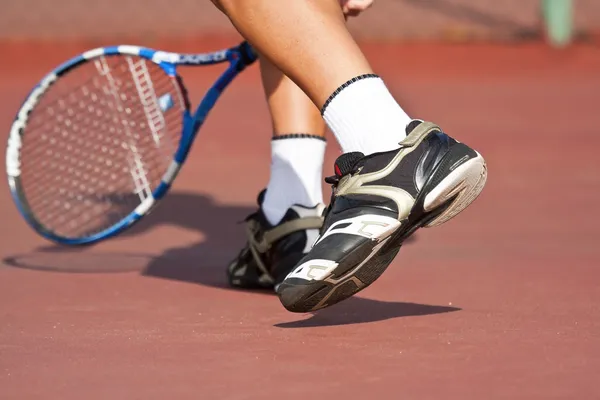 Tennis spelare ben och fötter på domstolen — Stockfoto