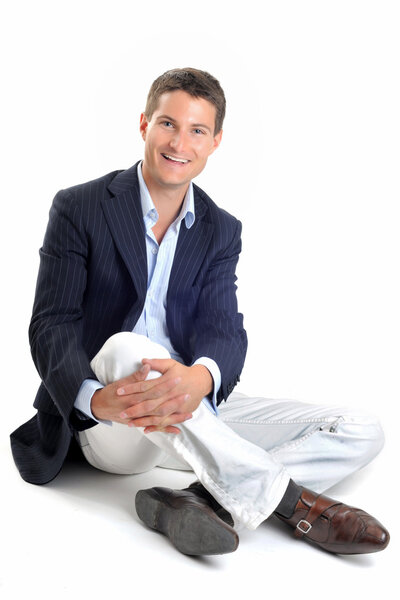 Young smiling business man in front of white background