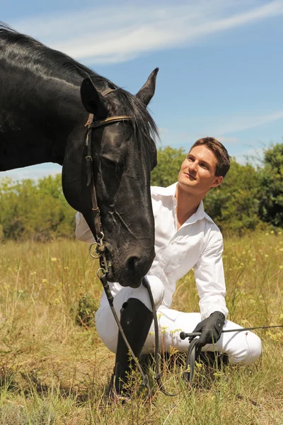 Young man and horse — Stock Photo, Image