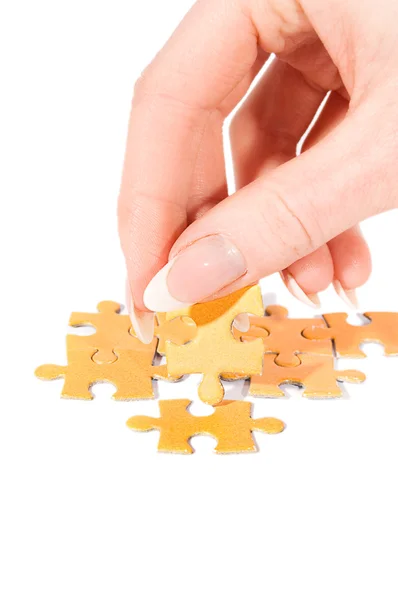 stock image Putting right piece in puzzle