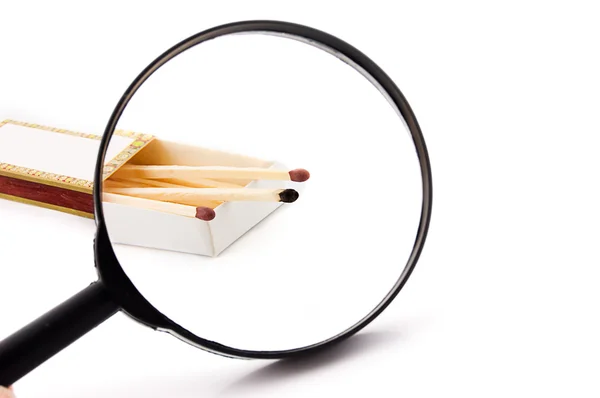 Matches and magnifying glass — Stock Photo, Image