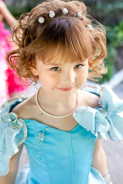 Portrait of a beautiful girl in a blue dress — Stock Photo, Image