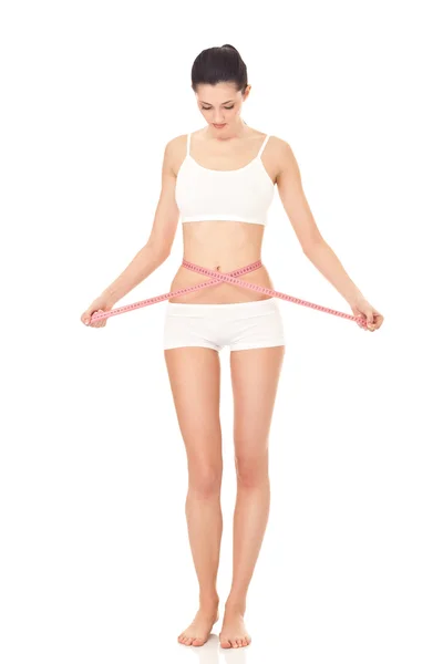 Girl measuring her waistline — Stock Photo, Image