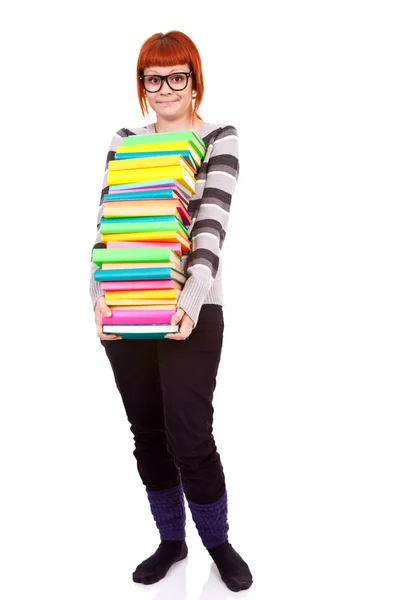 Несчастная школьница со стопкой цветных книг — стоковое фото