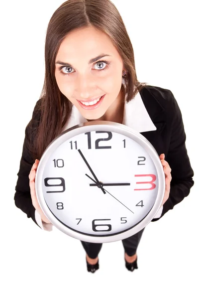 Businesswoman in suit holding a clock Stock Picture