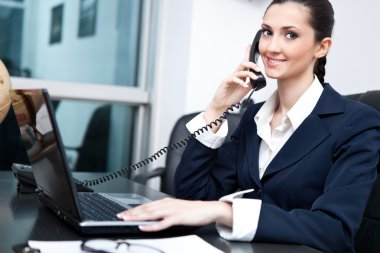 Businesswoman taking telephone call clipart