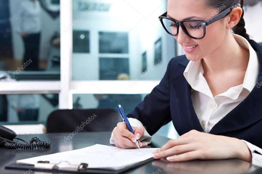 Young businesswoman signing a contract