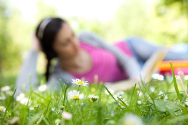 Woman lying on grass clipart