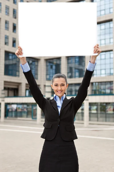 Business woman holding raised banner — Stock Photo, Image