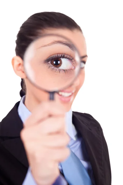 Woman looks through magnifying glass Stock Image