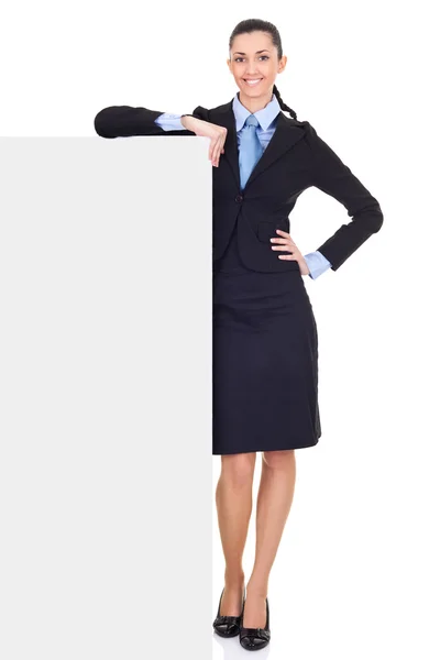 Businesswoman leaning on billboard — Stock Photo, Image
