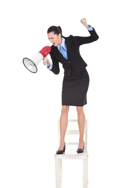 Angry boss with megaphone on chair — Stock Photo, Image