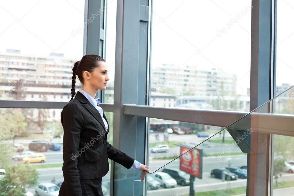 Businesswoman standing in a futuristic office building