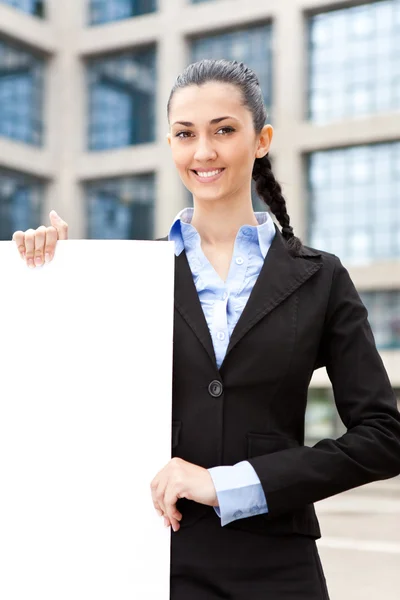 Businesswoman holding big blank paper — Stock Photo, Image