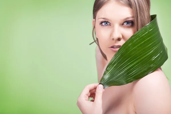 Young woman with green leaf — Stock Photo, Image