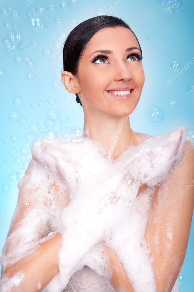 Smiling woman in bubble bath