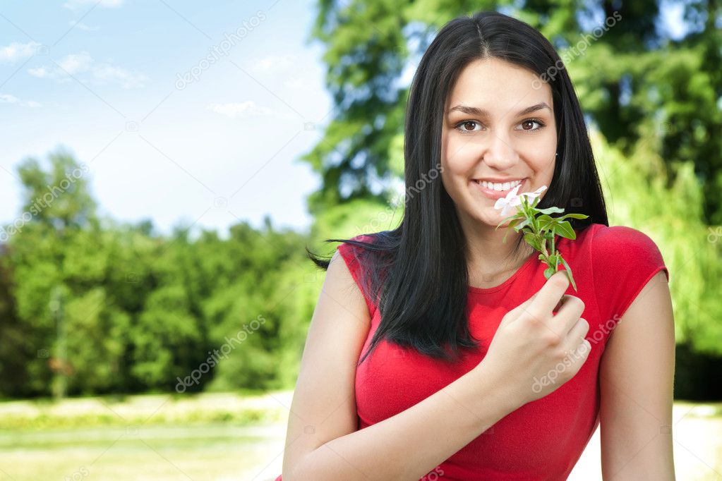 Smiling young woman with flower