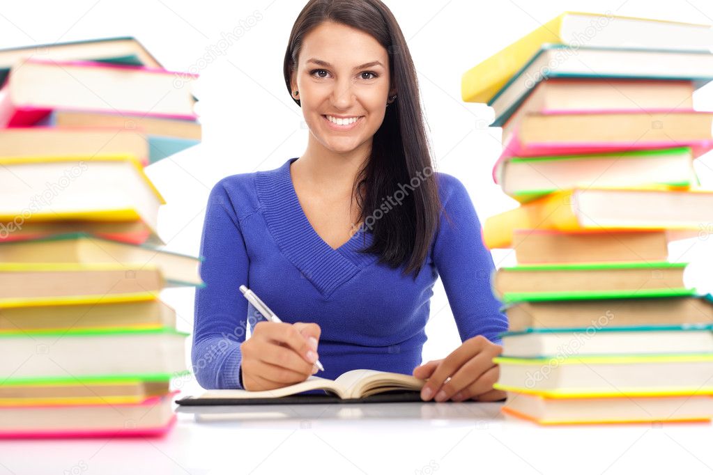 Smiling student wit lot of books