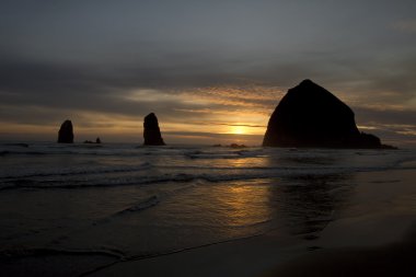 Sunset over Haystack Rock in Cannon Beach clipart
