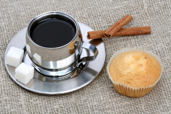 Tasse schwarzen Kaffee mit Muffin und Zimt — Stockfoto