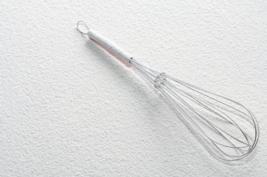 Wire whisk on flour