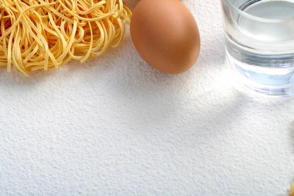 stock image Uncooked macaroni and egg on wheat flour