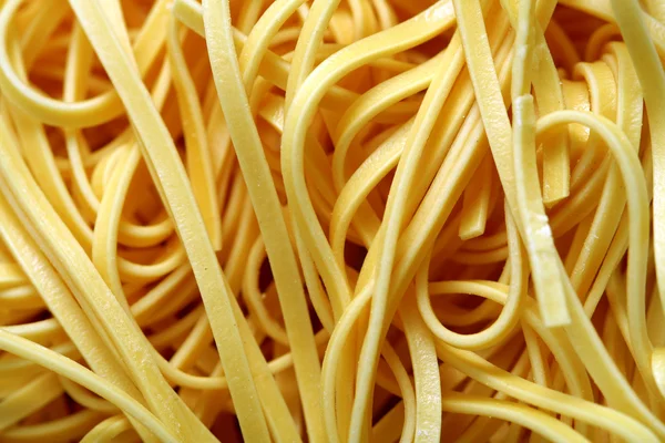 Uncooked egg noodles, macro — Stock Photo, Image