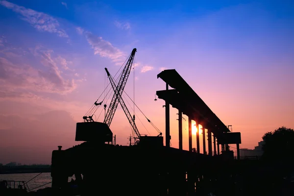 Cranes working at sunset — Stock Photo, Image