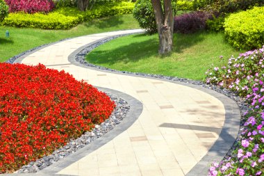 Beautiful summer garden with a walkway winding its way through clipart