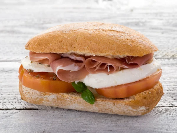 Sandwich with parma ham mozzarella and tomatoes — Stock Photo, Image