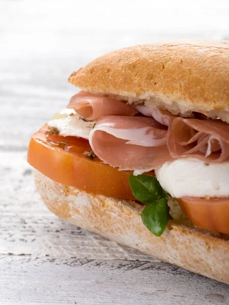 Sandwich with parma ham mozzarella and tomatoes — Stock Photo, Image