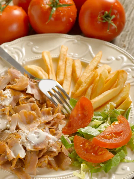 Kebap with salad and potatoes on dish — Stock Photo, Image