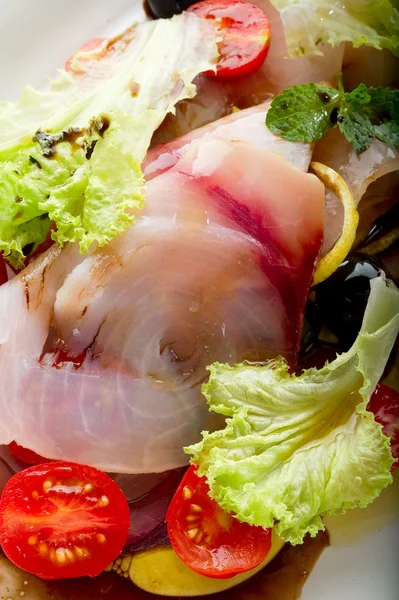 Swordfish carpaccio with sliced tomatoes — Stock Photo, Image