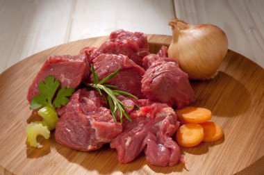 Raw stew meat with ingredients clipart