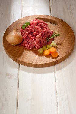 Raw grinded meat with ingredients clipart