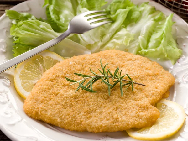 Cutlet breaded with salad on dish — Stock Photo, Image
