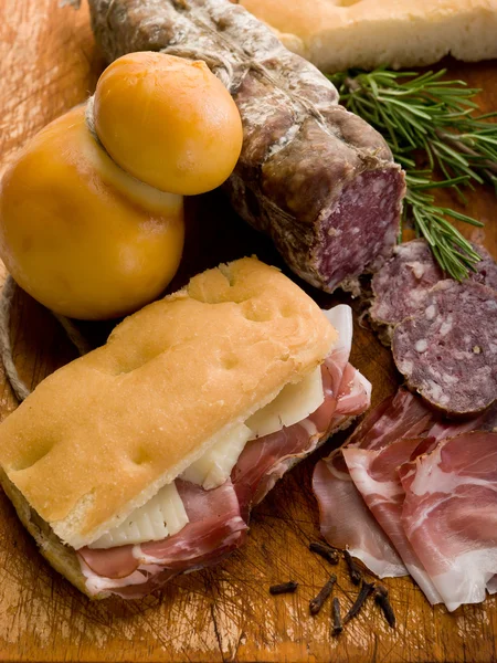 Focaccia con prosciutto salame e formaggio sopra tagliere — Foto Stock