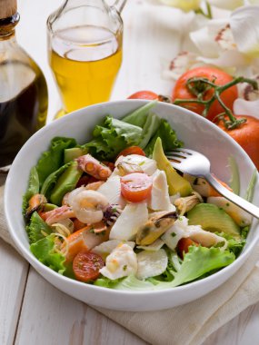 Mixed seafood salad with mozzarella and avocado clipart