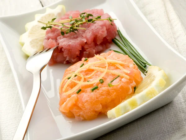 Salmon and tuna tartare with lemon and chive — Stock Photo, Image