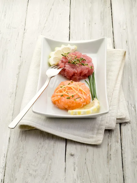 Salmon and tuna tartare with lemon and chive — Stock Photo, Image