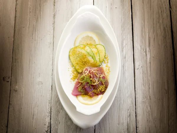 Tuna carpaccio with slice cucumber and grind pistachio — Stock Photo, Image