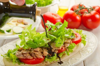 Balsamic vinegar over tuna salad clipart